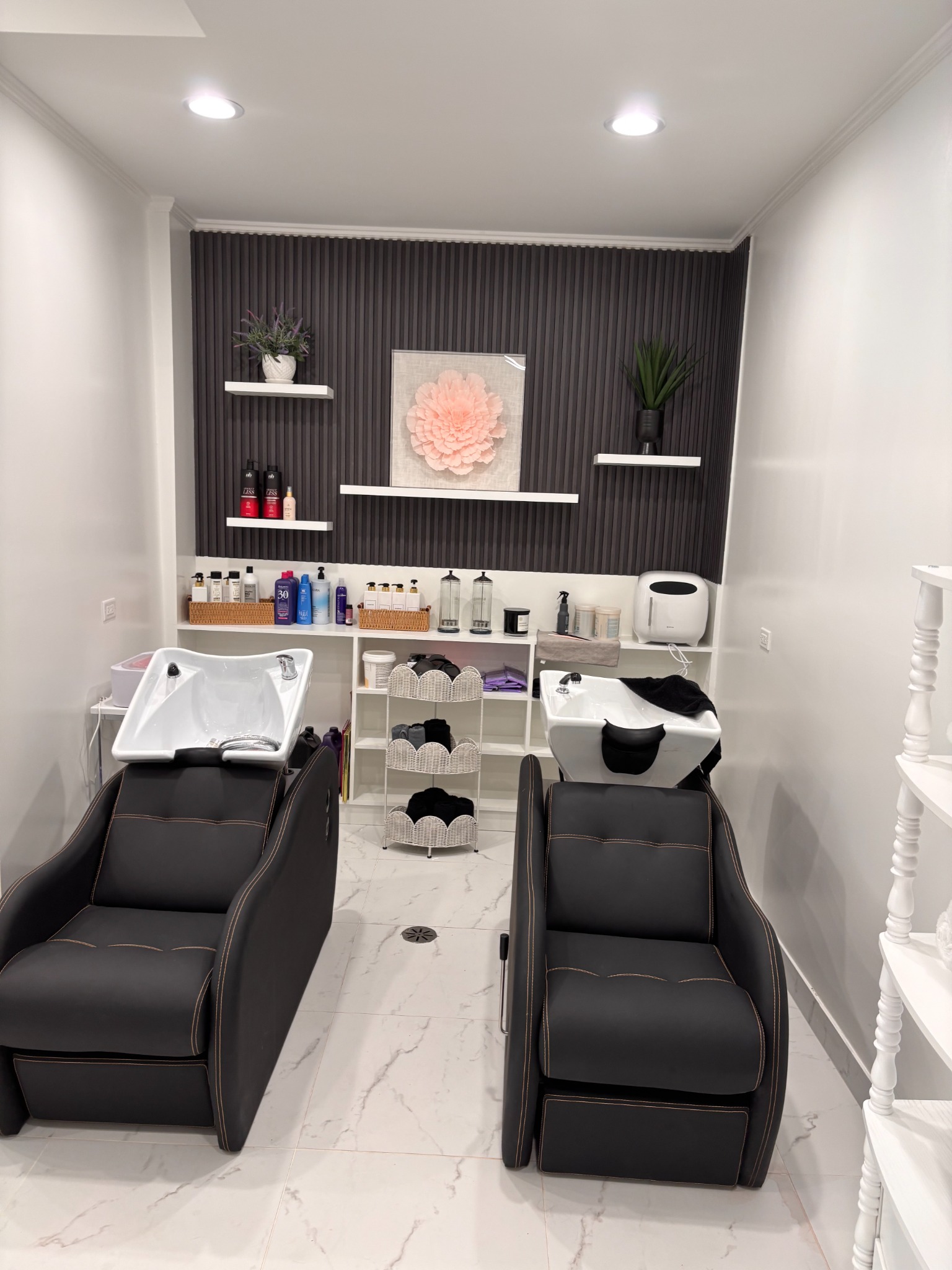 Bonita Salon shampoo back wall before workflow cabinetry, stone countertop, and utility sink