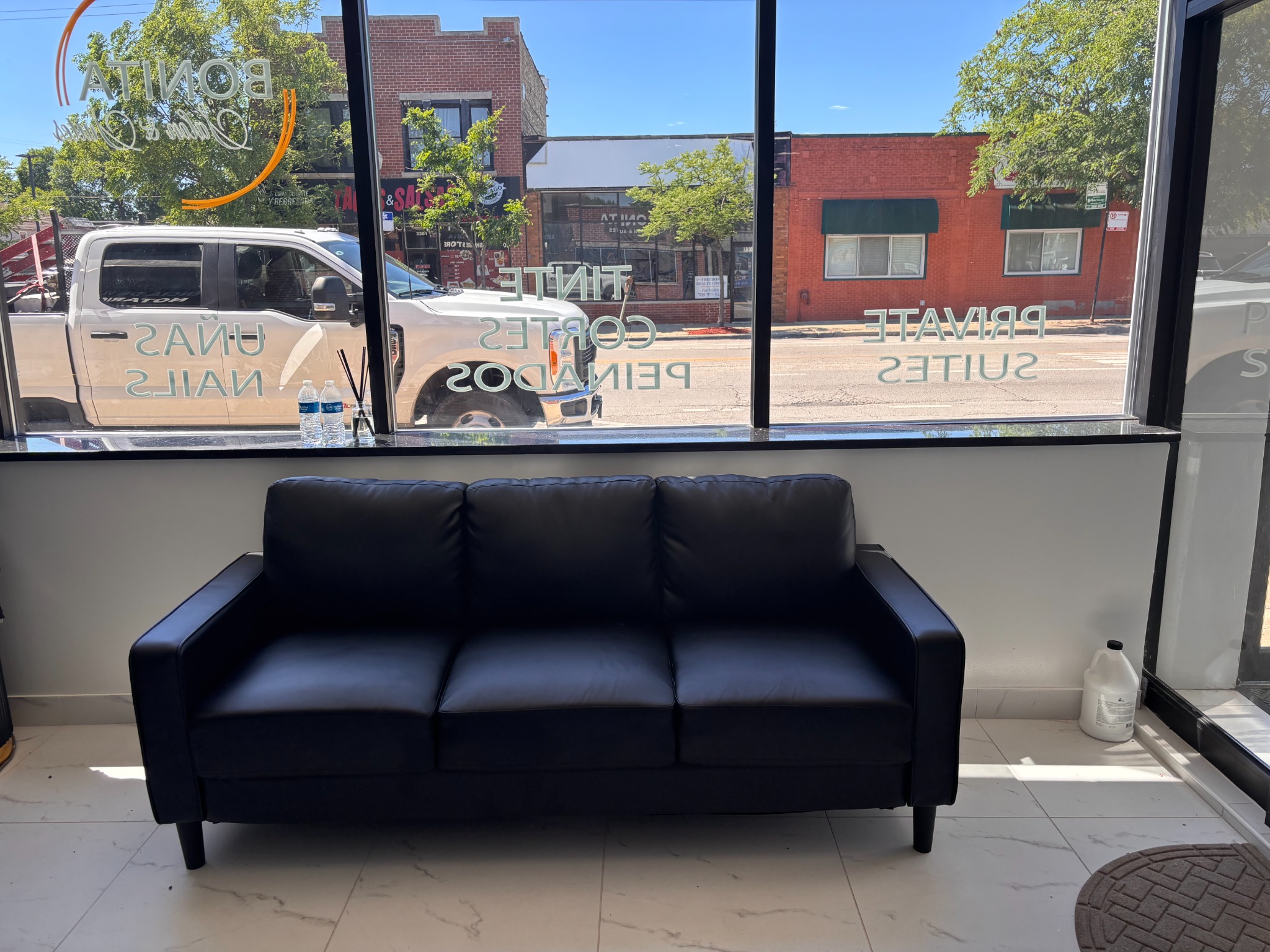 Bonita Salon entrance sofa before styling and updated window graphics